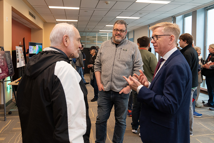 Dean Keith Webster and Assistant Teaching Professor Tom Corbett speak with Hillard Lazarus, a member of the Libraries Dean’s Advocacy Council.