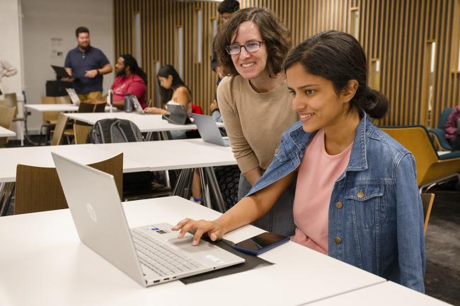 Librarian Sarah Young assists a student at a GitHub workshop in Hunt Library.