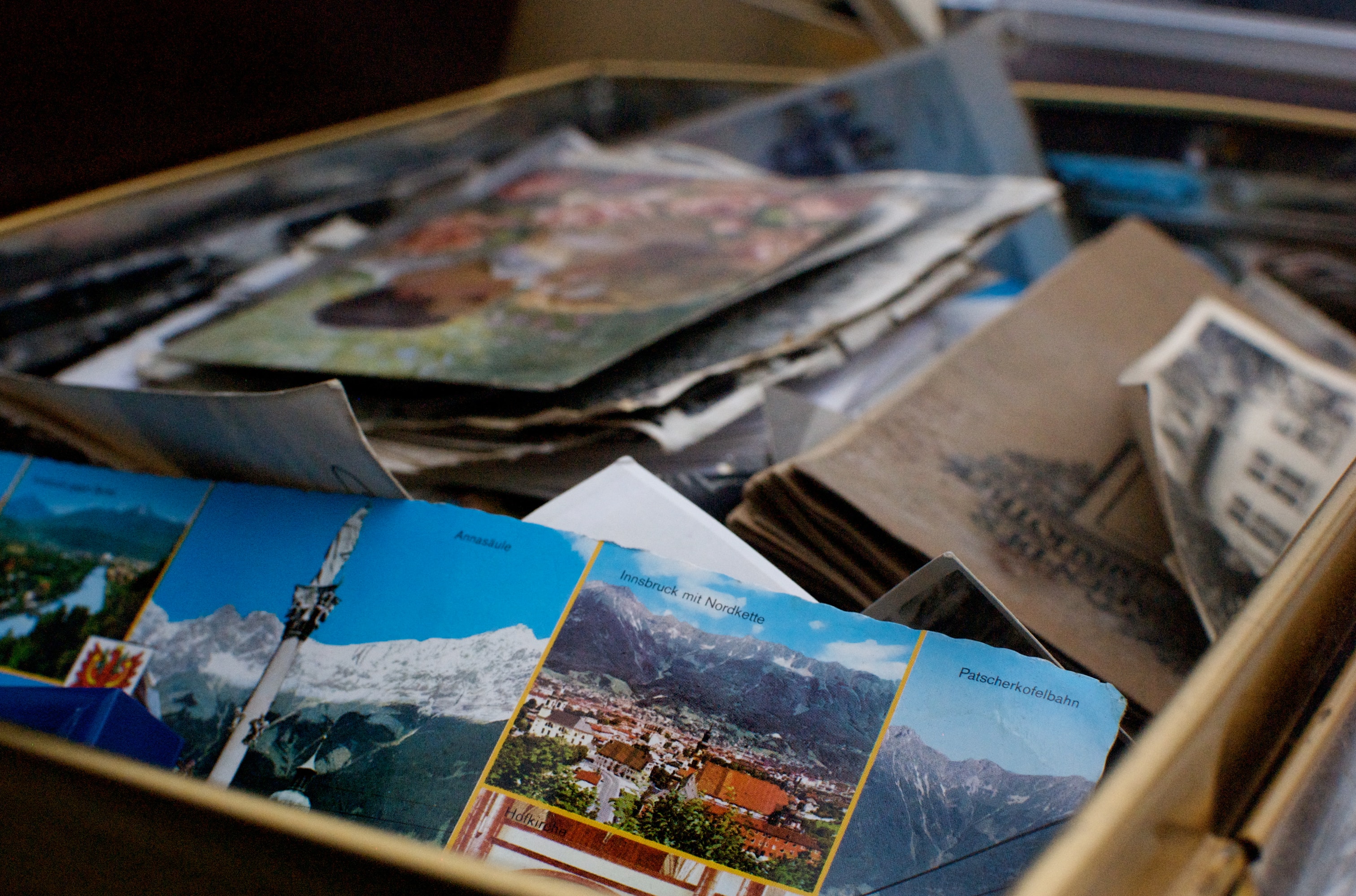 A box of unorganized color photographs.