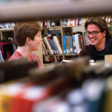 Image of two students at the library.
