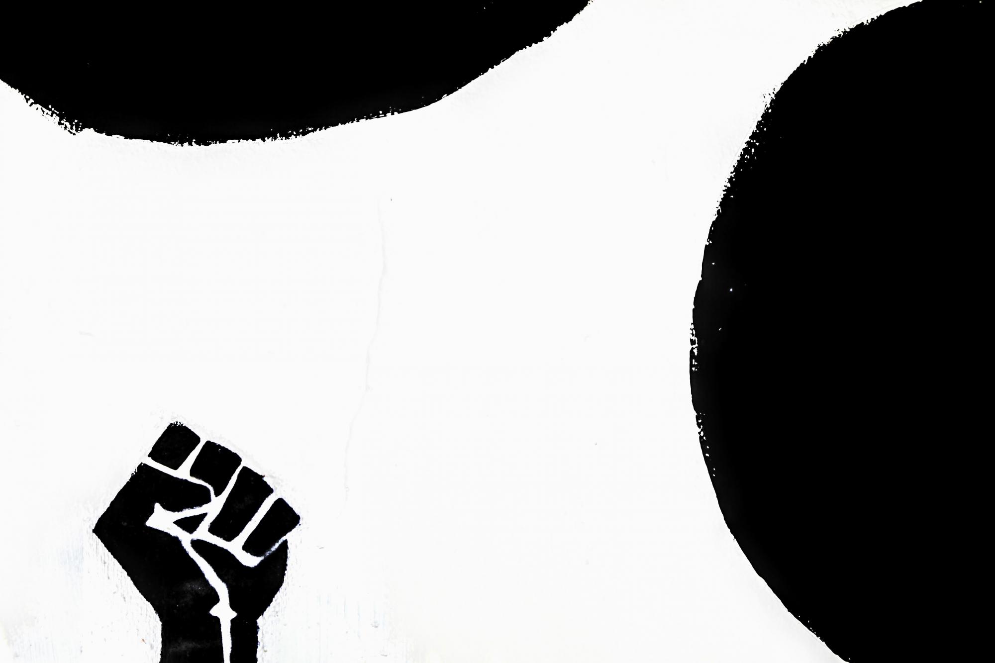 Illustration of black fist and abstract circular shapes.