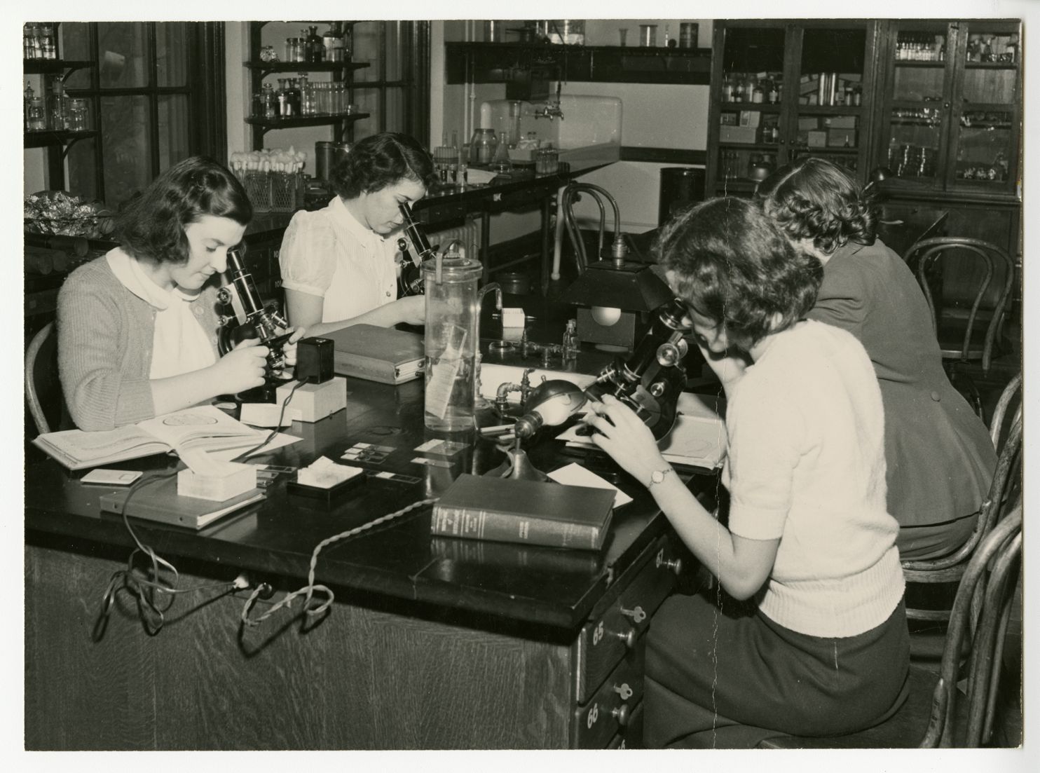 Students use microscopes in class