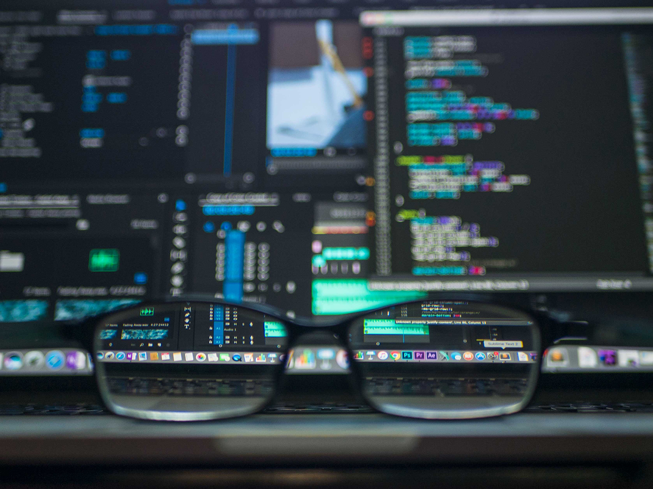 glasses in front of computer code