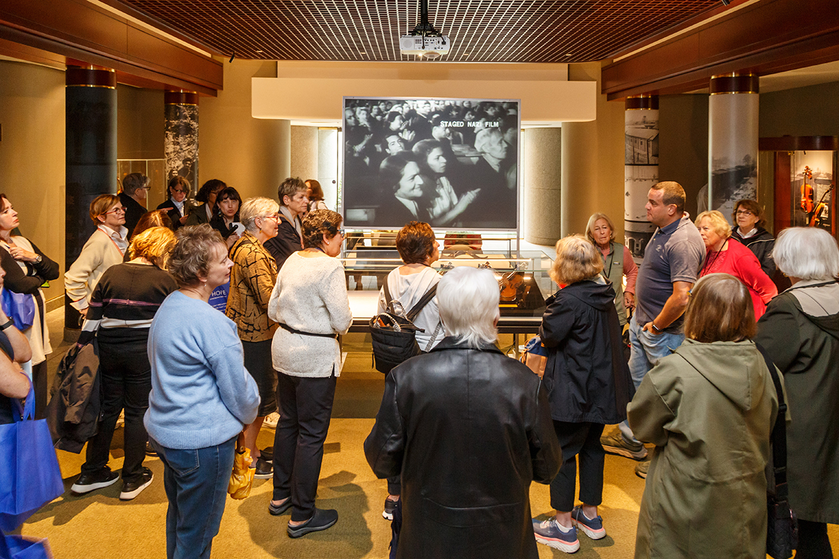 Avshi Weinstein, co-founder of Violins of Hope, leads docents through the exhibition.