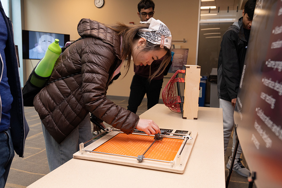 A student moves the arm of a Vigenère cipher.