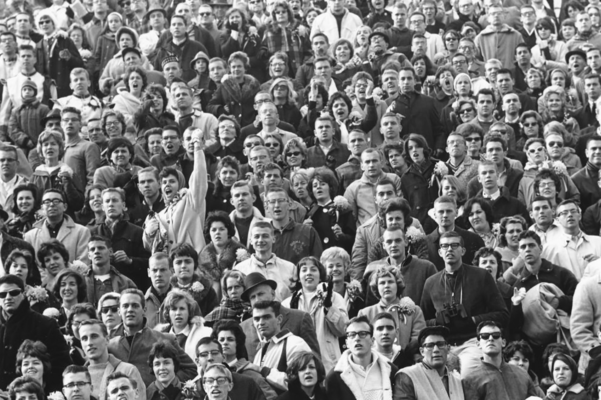 An audience of sports spectators cheering and observing a sporting event. (c.1950)