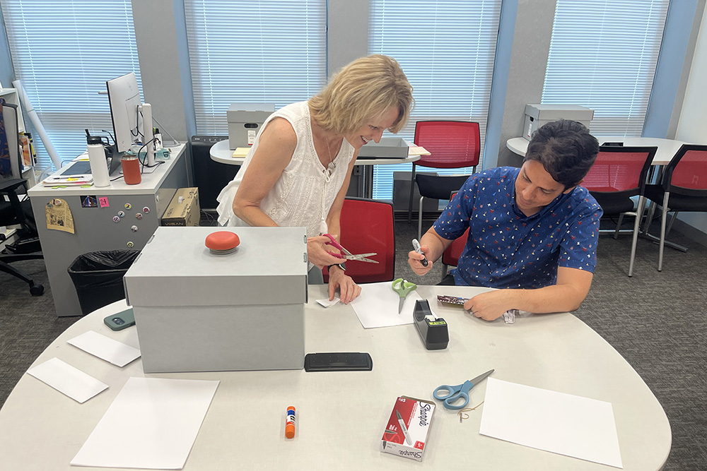 Kim Dolan and Alfredo González-Espinoza make props for their group's videos.