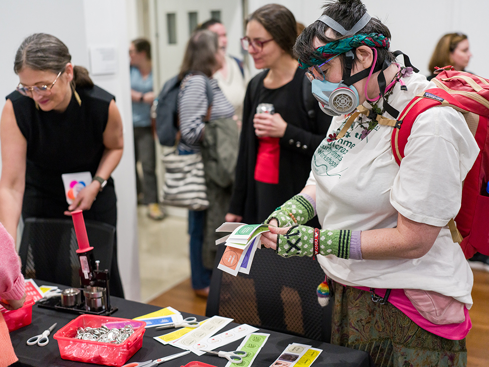 After the talk, attendees had the opportunity to enjoy refreshments and make buttons related to the themes of libraries, access, and inclusion.