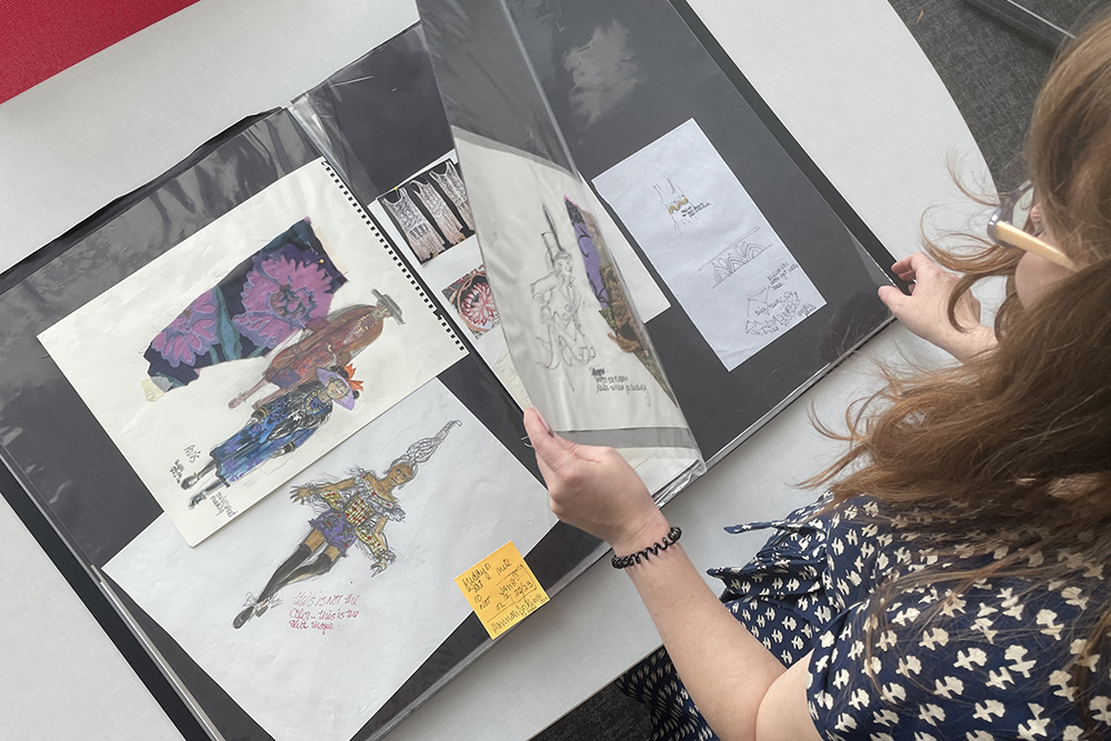 Community Collections Archivist Crystal Johnson looks through the Ann Roth Collection