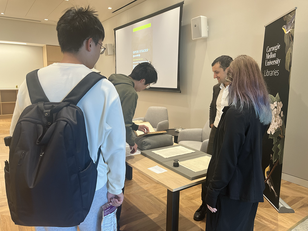 Attendees who arrived early took some time to examine the rare books on display before finding their seats.