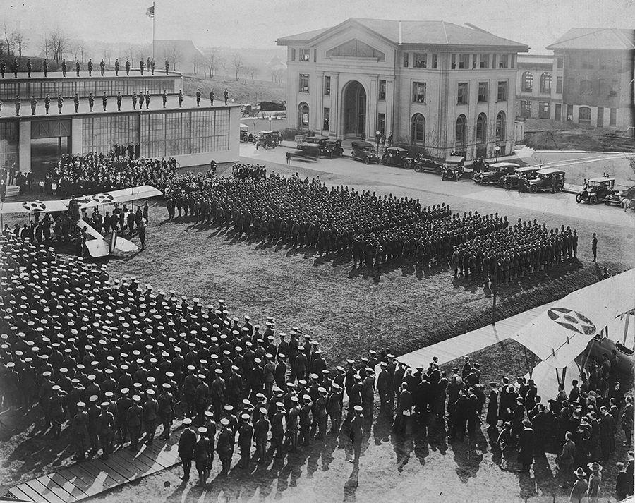 Dedication of the Langley Aeronautical Laboratory, 1918. Langley Aeronautical Laboratory was built in just twenty-three working days to provide a space for soldiers to learn how to repair airplanes. The dedication featured remarks from local dignitaries, troops in formation, and planes driven across campus to be housed in the new building. The building was named for Samuel Langley, an aviation pioneer and the first director of the Allegheny Observatory. World War I Records Carnegie Mellon University Archives.