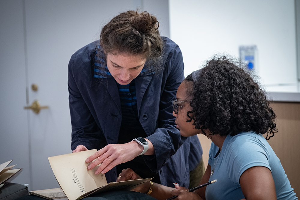 Special Collections Coordinator Catherine Blauvelt with a student