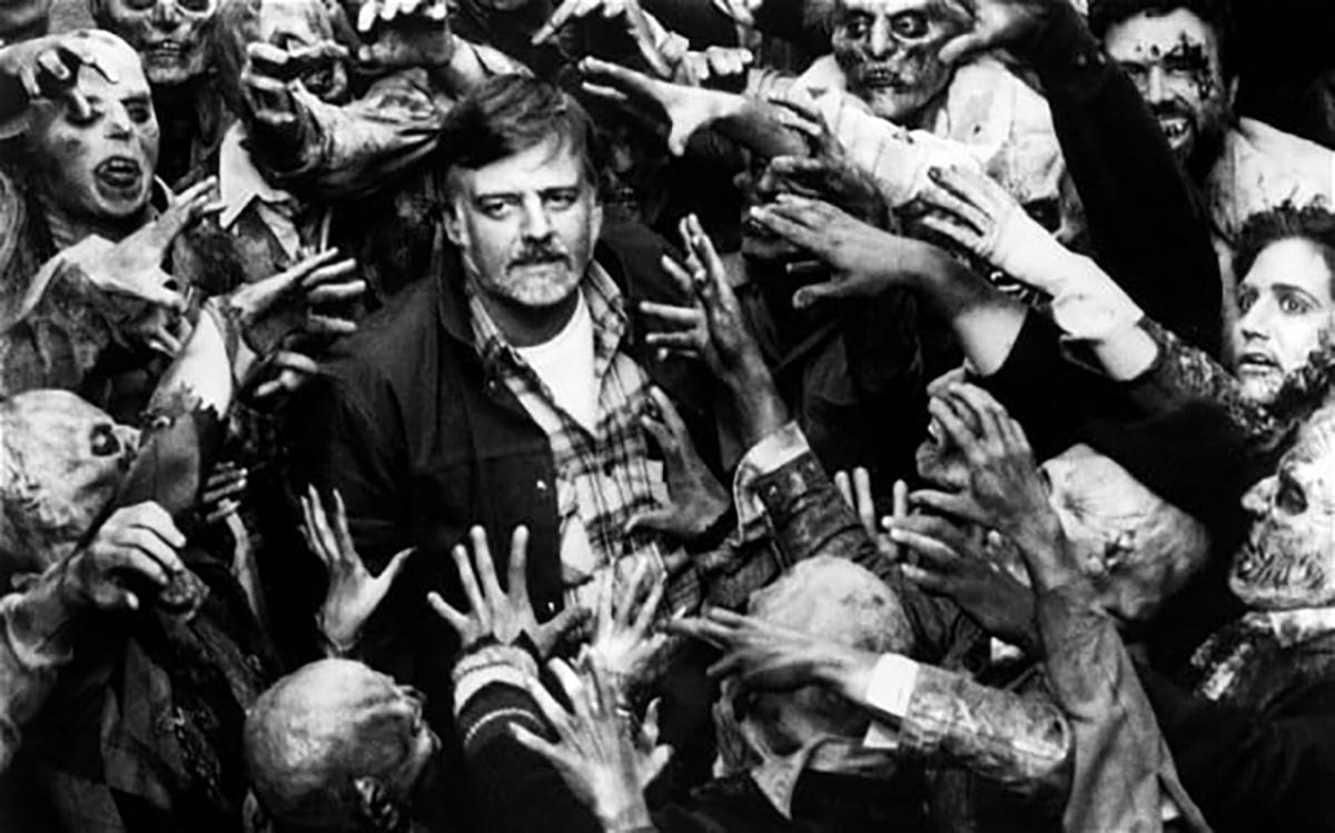 George Romero surrounded by zombies in the photo op.