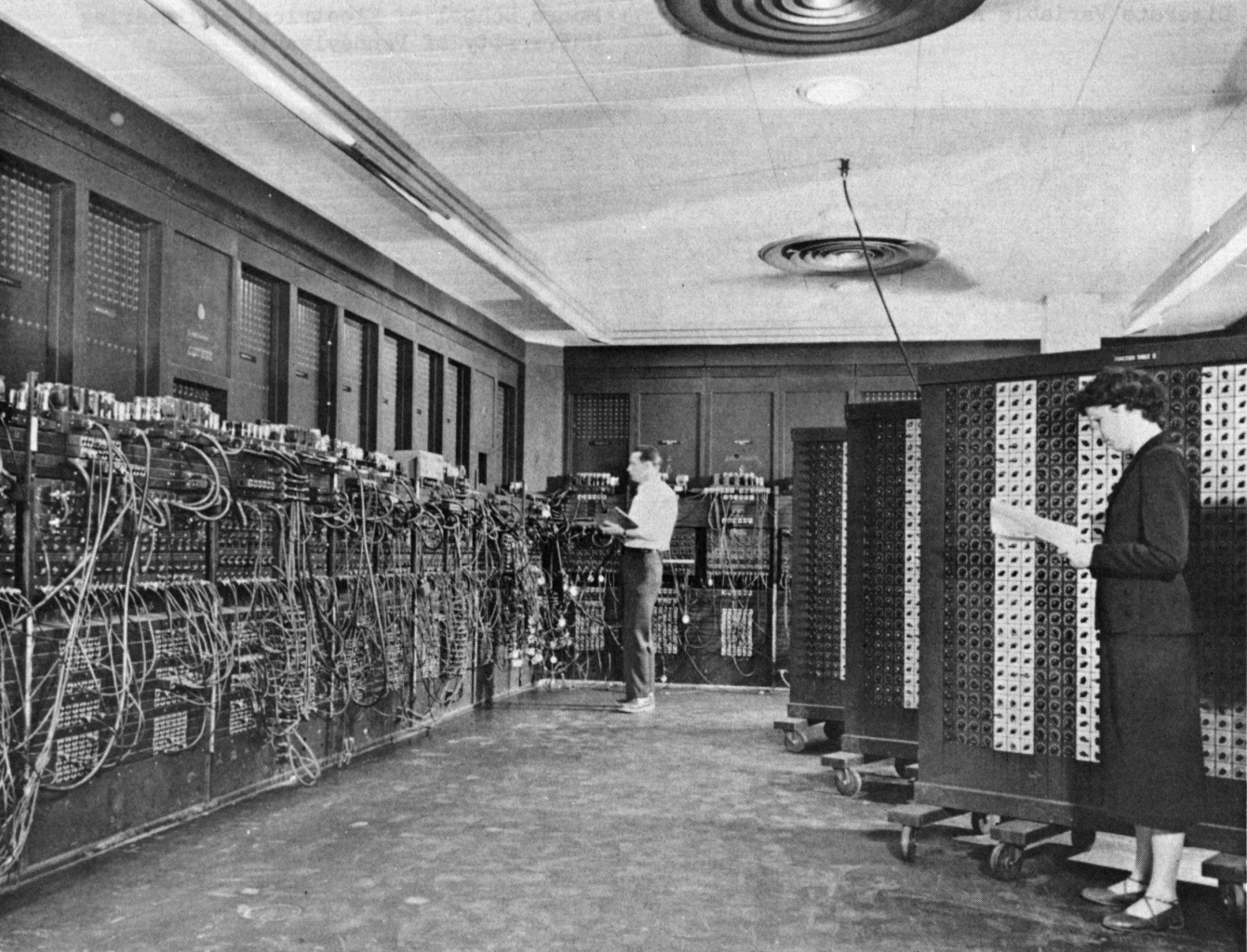 Two engineers working on ENIAC, one of the first programmable digital computers